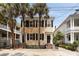 Charming two-story home with black shutters and palm trees at 8 Pitt St # A, Charleston, SC 29401