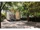Charming exterior view with lush trees, showcasing the home's character and surroundings at 8 Pitt St # A, Charleston, SC 29401