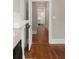 A view of the hallway featuring hardwood floors and neutral wall paint, with an open doorway leading to the kitchen at 8 Pitt St # A, Charleston, SC 29401