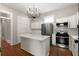 Bright kitchen featuring white cabinets, a center island with quartz countertop, stainless appliances, and hardwood floors at 8 Pitt St # A, Charleston, SC 29401