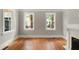 Living room with hardwood floors, white trim, and fireplace at 8 Pitt St # A, Charleston, SC 29401