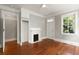 Living room with a fireplace and decorative mantle and hardwood floors at 8 Pitt St # A, Charleston, SC 29401