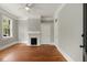 Living room with hardwood floors, white trim, and fireplace at 8 Pitt St # A, Charleston, SC 29401