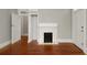 Living room with a fireplace and decorative mantle and hardwood floors at 8 Pitt St # A, Charleston, SC 29401