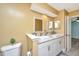 Bathroom with dual vessel sinks, modern lighting, and a view of an additional room at 8507 William Moultrie Dr, North Charleston, SC 29420