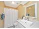 Bright bathroom featuring a stylish vanity with a vessel sink and a shower with a white curtain at 8507 William Moultrie Dr, North Charleston, SC 29420