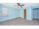 Comfortable bedroom features wood-look flooring, a ceiling fan, and access to other rooms at 8507 William Moultrie Dr, North Charleston, SC 29420