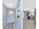Inviting foyer features gray-blue walls, wood-look floors, with a view to the updated kitchen at 8507 William Moultrie Dr, North Charleston, SC 29420