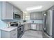 Well-appointed kitchen boasts gray cabinetry, stainless appliances, and durable countertops at 8507 William Moultrie Dr, North Charleston, SC 29420