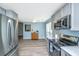 Updated kitchen with stainless appliances, view to the breakfast nook, and gray cabinets at 8507 William Moultrie Dr, North Charleston, SC 29420
