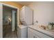 A modern laundry room with a stacked washer and dryer, complemented by ample counter space at 8507 William Moultrie Dr, North Charleston, SC 29420