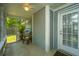 View of a screened-in porch with a ceiling fan, chair, and an entrance to the home at 8507 William Moultrie Dr, North Charleston, SC 29420