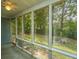 View from the screened-in porch looking out to the backyard and green space at 8507 William Moultrie Dr, North Charleston, SC 29420