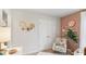 Charming Bedroom boasts an accent wall, floral chair and white furniture at 8840 Shovelnose Ct, North Charleston, SC 29406