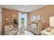 Charming Bedroom boasts an accent wall, floral chair and white furniture at 8840 Shovelnose Ct, North Charleston, SC 29406
