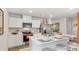 Modern kitchen with white cabinets, stainless steel appliances, and island with breakfast bar at 8840 Shovelnose Ct, North Charleston, SC 29406