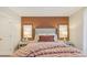 Comfortable main bedroom featuring a plush bed with an upholstered headboard and accent wall at 8840 Shovelnose Ct, North Charleston, SC 29406