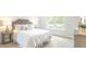 Bright bedroom featuring natural light from a window, a comfortable bed, and neutral walls at 8854 Shovelnose Ct, North Charleston, SC 29406