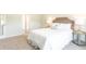 Bright bedroom featuring neutral walls, carpeted floors, and a comfortable bed at 8854 Shovelnose Ct, North Charleston, SC 29406