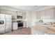 Bright kitchen features stainless steel appliances, granite countertops, and grey cabinets at 8854 Shovelnose Ct, North Charleston, SC 29406
