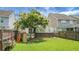 Spacious backyard with green grass, a playset, and surrounding fence at 8921 Skipping Rock Ln, Summerville, SC 29485