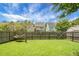 Green backyard with a wooden fence and mature landscaping, featuring a relaxing hammock at 8921 Skipping Rock Ln, Summerville, SC 29485