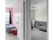 Charming bedroom featuring dual twin beds, soft pink accent wall, and natural lighting at 8921 Skipping Rock Ln, Summerville, SC 29485
