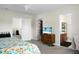 Bright bedroom boasts a ceiling fan, TV on dresser, and convenient access to the ensuite bathroom and walk-in closet at 8921 Skipping Rock Ln, Summerville, SC 29485