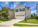 Charming two-story home with a two-car garage, manicured lawn, and classic curb appeal at 8921 Skipping Rock Ln, Summerville, SC 29485