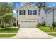 Charming two-story home with a two-car garage, manicured lawn, and classic curb appeal at 8921 Skipping Rock Ln, Summerville, SC 29485