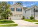 Charming two-story home with a two-car garage, manicured lawn, and classic curb appeal at 8921 Skipping Rock Ln, Summerville, SC 29485