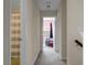 Well-lit hallway featuring neutral paint and carpet, leading to bedrooms and bathroom at 8921 Skipping Rock Ln, Summerville, SC 29485