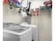 Laundry room with a modern washer and dryer, as well as shelving for storage and supplies at 8921 Skipping Rock Ln, Summerville, SC 29485