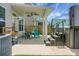 A covered patio features a hot tub, seating, and access to the house at 8921 Skipping Rock Ln, Summerville, SC 29485