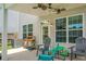 A covered patio boasts a ceiling fan, dining and seating areas, and access to the backyard at 8921 Skipping Rock Ln, Summerville, SC 29485