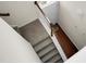 Elegant stairwell featuring carpeted steps and white railing leading to a bright entryway at 8921 Skipping Rock Ln, Summerville, SC 29485
