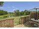 Inviting back deck with table and chairs, overlooking a tranquil pond and lush greenery at 925 Dills Bluff Rd # 34, Charleston, SC 29412