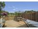 A cozy deck with a hammock and table, overlooking a lake and lush greenery in the backyard at 925 Dills Bluff Rd # 34, Charleston, SC 29412