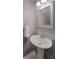 Neutral half-bathroom featuring a white sink and pedestal with a framed mirror and towel rack at 925 Dills Bluff Rd # 34, Charleston, SC 29412