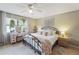 Cozy bedroom with a ceiling fan, light wood floors, and comfortable queen-sized bed at 925 Dills Bluff Rd # 34, Charleston, SC 29412