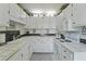 Bright kitchen with white cabinets, tiled countertops, and a clean, functional layout at 925 Dills Bluff Rd # 34, Charleston, SC 29412