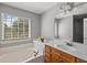 Relaxing bathroom features a soaking tub, large window, and ample counter space at 9313 Sweetbay Ct, Ladson, SC 29456