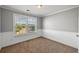 Carpeted bedroom with large window for natural light and gray paint at 9313 Sweetbay Ct, Ladson, SC 29456