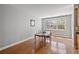 Dining room features hardwood floors, large window, and neutral paint colors at 9313 Sweetbay Ct, Ladson, SC 29456