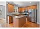 Charming kitchen with stainless steel appliances, a center island, and wooden cabinetry at 9313 Sweetbay Ct, Ladson, SC 29456