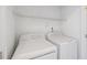 Laundry room area with a white washer and dryer and wire shelving at 9313 Sweetbay Ct, Ladson, SC 29456