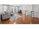Cozy living room features hardwood floors, a large sofa, and plenty of natural light at 9313 Sweetbay Ct, Ladson, SC 29456