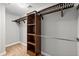 Walk-in closet with wooden shelves and a metal clothes rod offers lots of space at 9313 Sweetbay Ct, Ladson, SC 29456