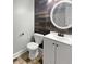 Modern bathroom features white vanity, decorative wood-style tile accent wall, and updated fixtures at 932 Portabella Ln, Charleston, SC 29412