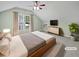 Bright bedroom features carpet, a ceiling fan, and an adjacent window for natural light at 932 Portabella Ln, Charleston, SC 29412